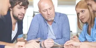 think Team of five people collaborating on a project, looking at a tablet.