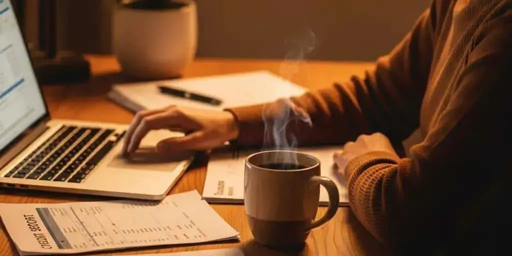 Cozy Workspace With A Person Reviewing Their Credit Score On A Laptop Emphasizing Financial Management Bc404fe8 Fe6e 46d9 A854 575aace5e66b 3 Cozy workspace with a person reviewing their credit score on a laptop, emphasizing financial management